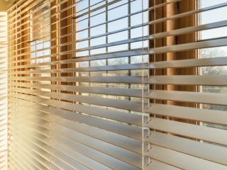 Faux wood blinds installed on modern living room windows